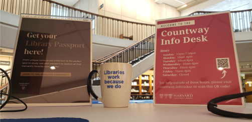 Signage and a coffee mug at the Countway Information Desk