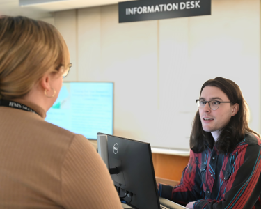 Staff member helping a patron at the Info Desk